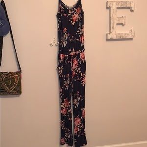 size medium, navy floral jumpsuit with pockets.